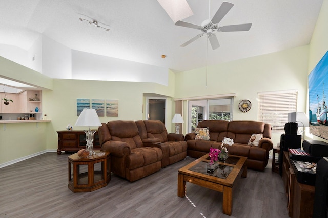 living room featuring hardwood / wood-style flooring, high vaulted ceiling, and ceiling fan