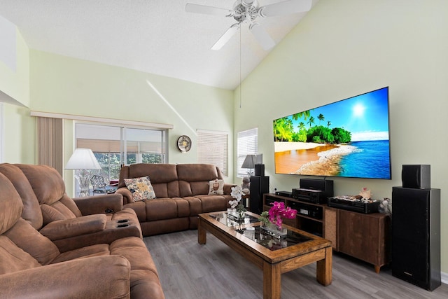 living room with ceiling fan, wood-type flooring, and high vaulted ceiling