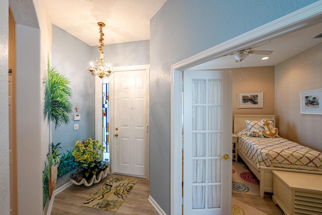 foyer with a notable chandelier and light hardwood / wood-style flooring