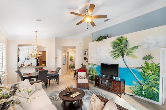 living room featuring ceiling fan with notable chandelier, light hardwood / wood-style flooring, and ornamental molding