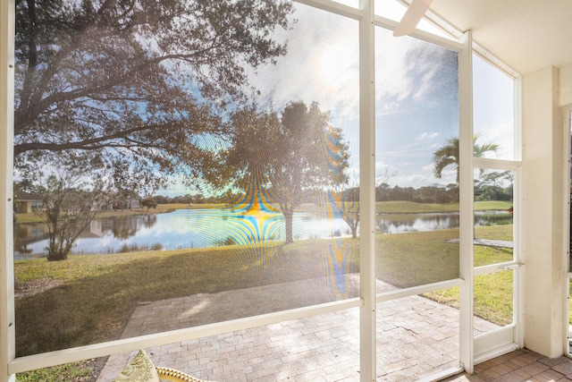 unfurnished sunroom with a water view