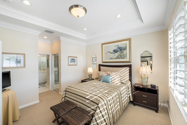 carpeted bedroom featuring connected bathroom, crown molding, and a raised ceiling