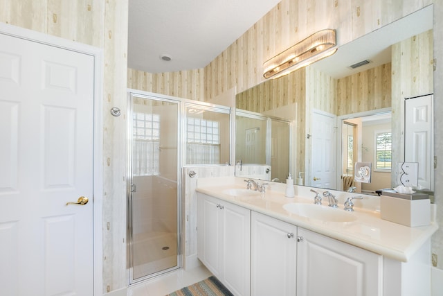 bathroom with vanity, a shower with shower door, and tile patterned floors