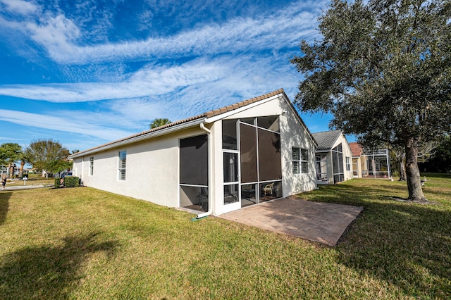 view of side of property with a yard and a patio