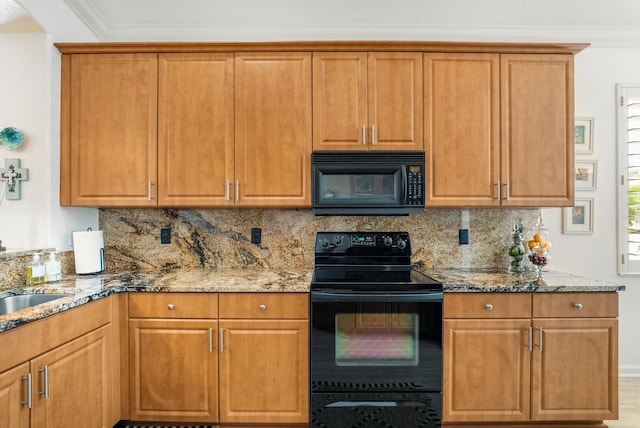 kitchen with crown molding, decorative backsplash, light stone counters, and black appliances