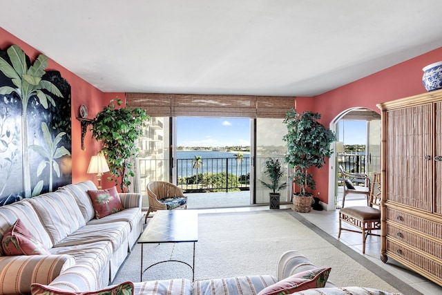 living room featuring plenty of natural light and a water view