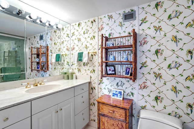 bathroom with walk in shower, vanity, and toilet