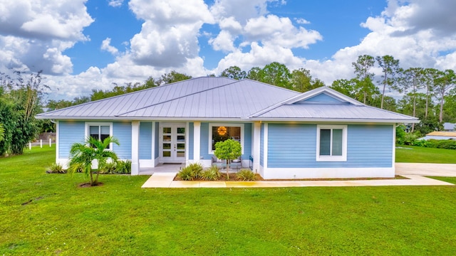 ranch-style home with french doors and a front yard