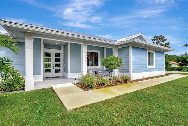 entrance to property featuring a yard