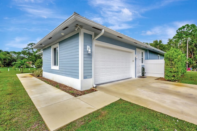 view of home's exterior with a garage and a yard