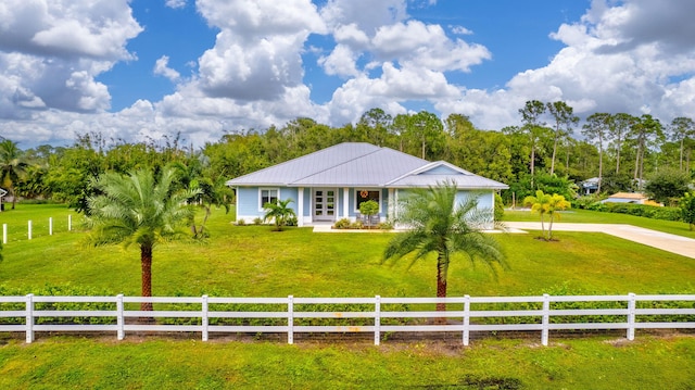 view of front facade featuring a front lawn and a rural view