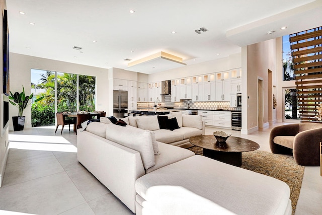 living room featuring beverage cooler and light tile patterned floors