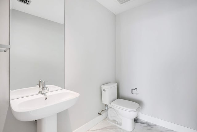 bathroom featuring sink and toilet