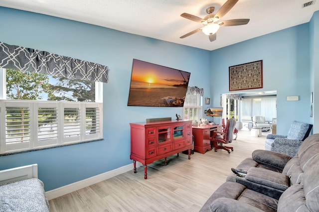 living room featuring ceiling fan and light wood-type flooring