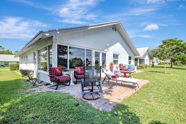 back of house with a yard and a patio area