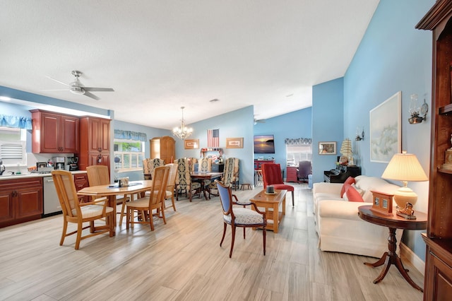 interior space featuring lofted ceiling, ceiling fan with notable chandelier, and light hardwood / wood-style flooring