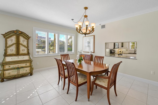 tiled dining space with an inviting chandelier, sink, crown molding, and a textured ceiling