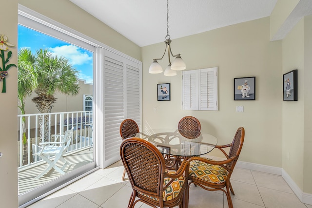 tiled dining area featuring an inviting chandelier