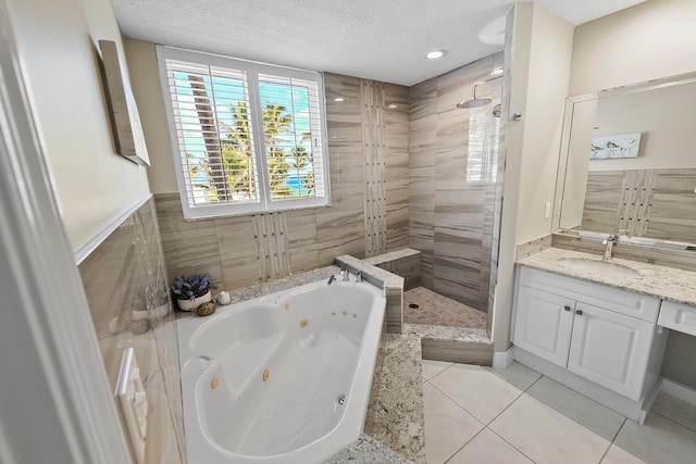 bathroom featuring tile patterned floors, shower with separate bathtub, a textured ceiling, and vanity