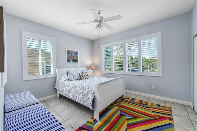 tiled bedroom featuring ceiling fan