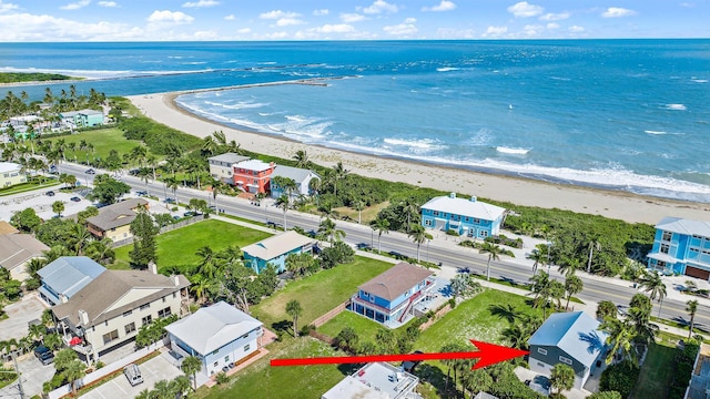 birds eye view of property featuring a view of the beach and a water view