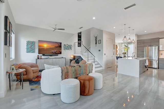 living room featuring sink and ceiling fan