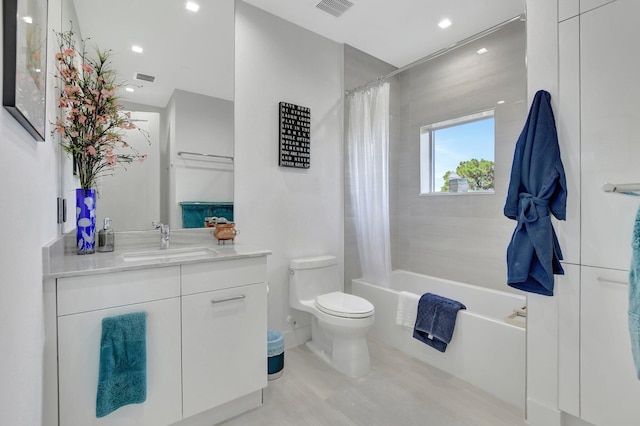 full bathroom featuring vanity, toilet, and shower / bath combo with shower curtain