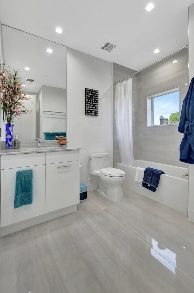 full bathroom featuring vanity, toilet, and shower / bath combo with shower curtain