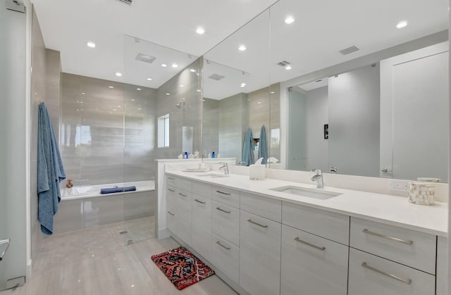 bathroom featuring vanity and plus walk in shower