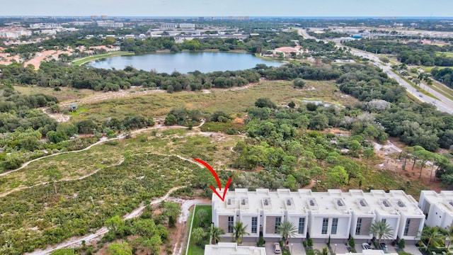 birds eye view of property with a water view