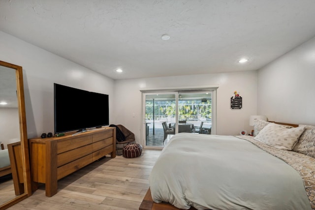 bedroom with light wood-type flooring and access to outside