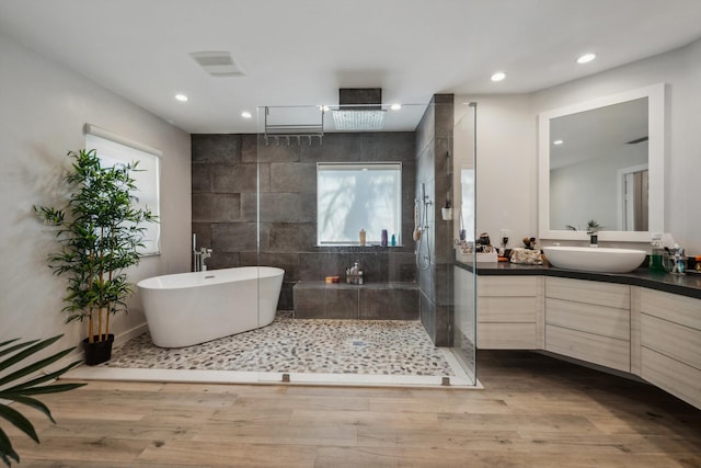 bathroom with vanity, hardwood / wood-style floors, and shower with separate bathtub