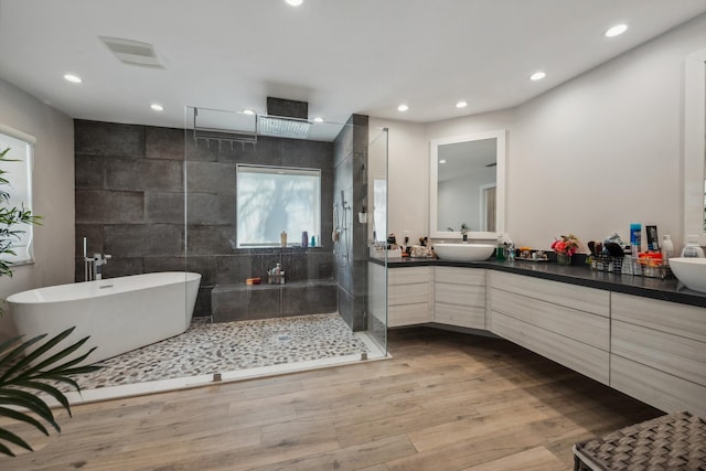 bathroom with vanity, hardwood / wood-style floors, and independent shower and bath