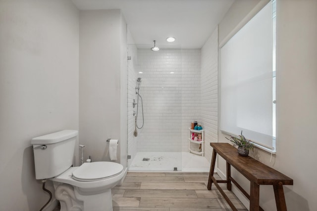 bathroom with tiled shower and toilet