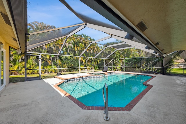 view of pool featuring a lanai, a patio area, and an in ground hot tub