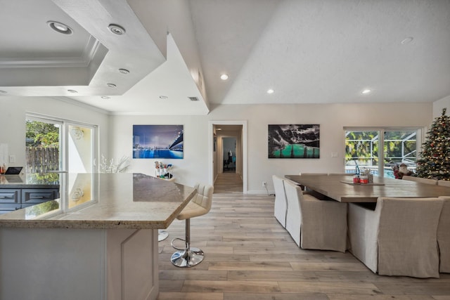 kitchen with white cabinetry, a center island, and light wood-type flooring