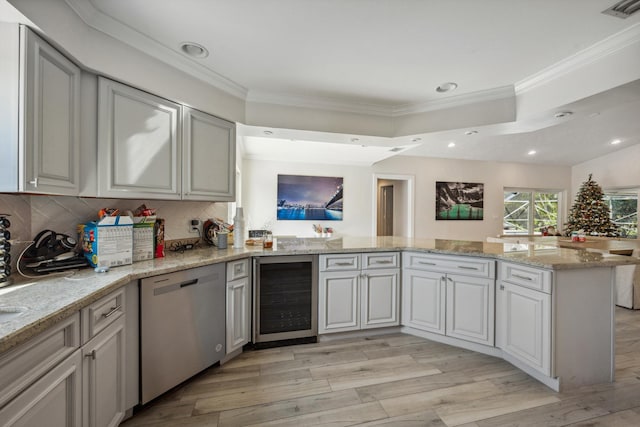 kitchen featuring dishwasher, wine cooler, ornamental molding, light hardwood / wood-style floors, and kitchen peninsula