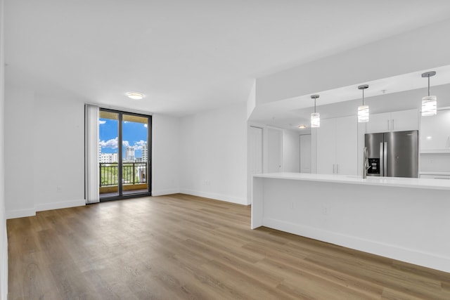 unfurnished living room featuring hardwood / wood-style flooring and expansive windows