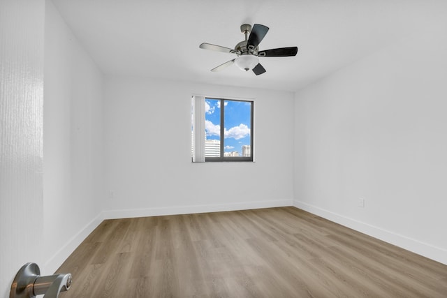 empty room featuring ceiling fan and light hardwood / wood-style flooring