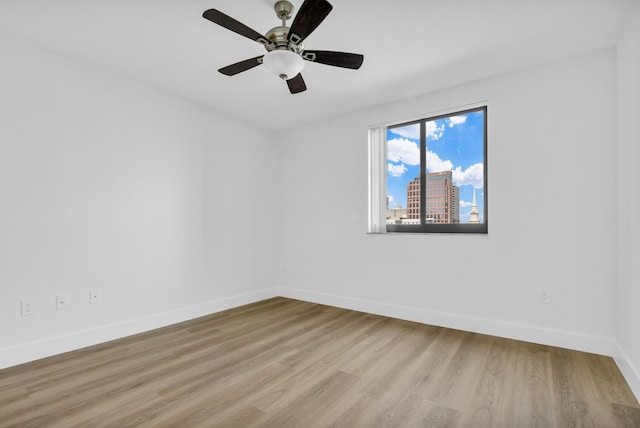 spare room featuring ceiling fan and light wood-type flooring