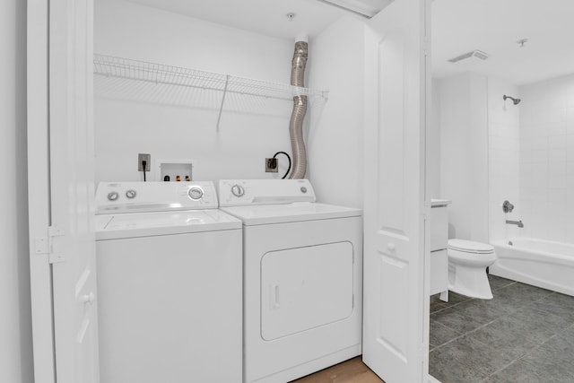 laundry room with washer and dryer, laundry area, and visible vents