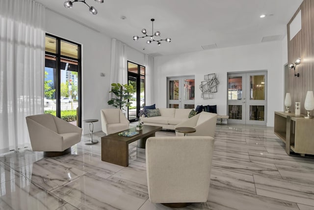 living room with a notable chandelier and french doors