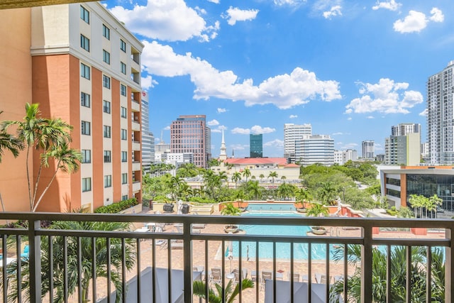 balcony featuring a water view and a city view