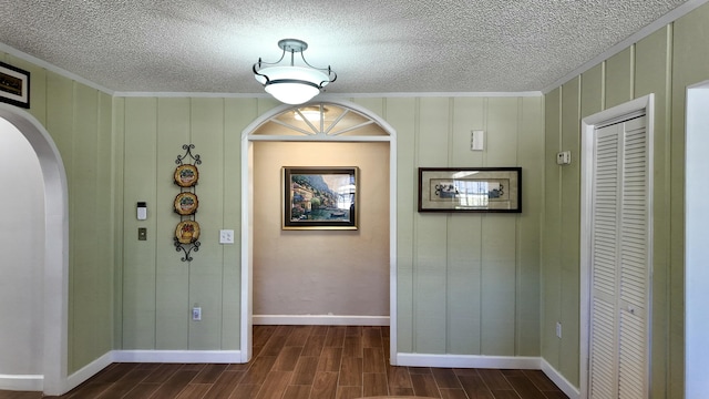 foyer featuring ornamental molding and a textured ceiling