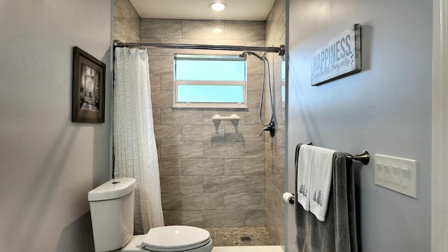 bathroom featuring toilet and walk in shower