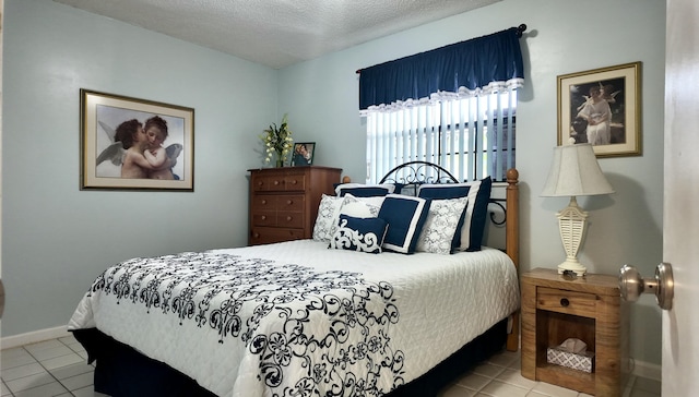 tiled bedroom with a textured ceiling