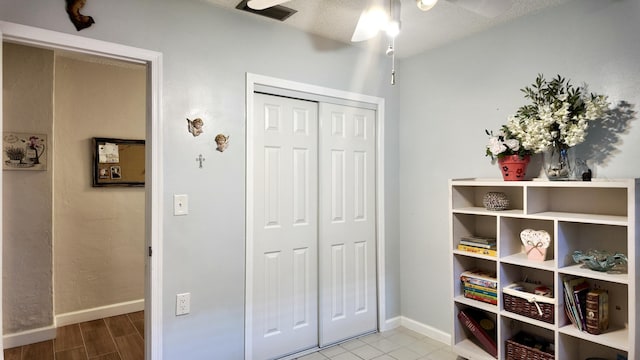 interior space with ceiling fan