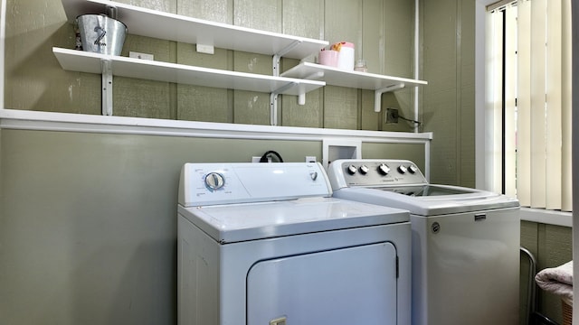 clothes washing area featuring separate washer and dryer