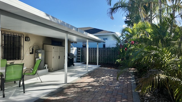 view of patio / terrace with grilling area and water heater