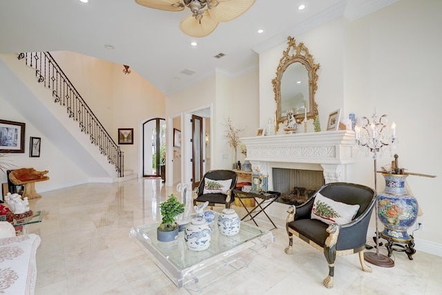 sitting room with ornamental molding and ceiling fan